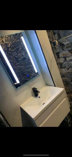 a bathroom with a sink and a window at Lisvarna House in Buncrana