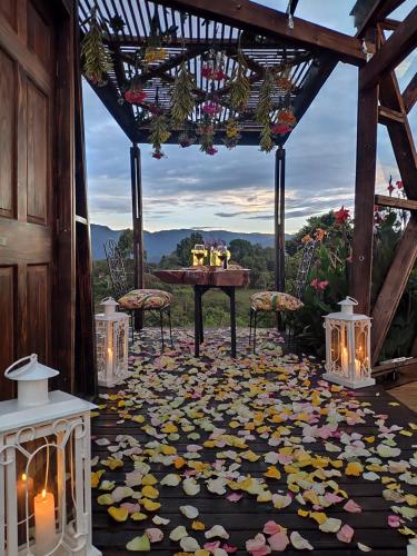 a patio with a table and flowers on the floor at Nacimiento Glamping in San Agustín