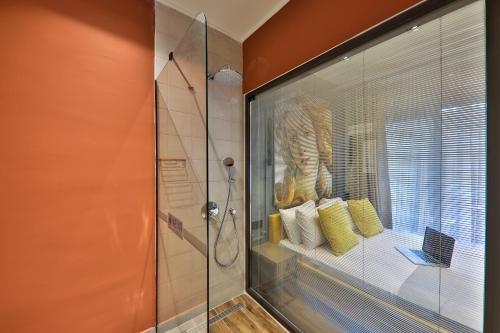 a bathroom with a shower with a glass shower stall at Neva Kaş in Kaş