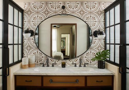 a bathroom with a mirror and a sink at Hotel Figueroa, Unbound Collection by Hyatt in Los Angeles
