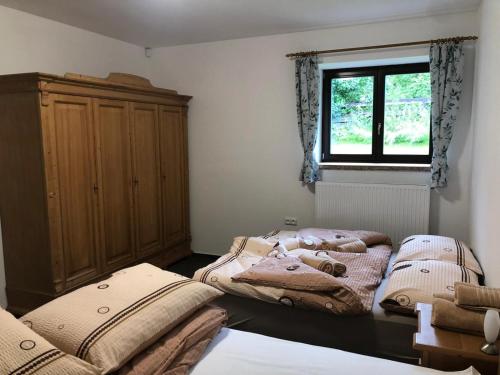 two beds in a room with a window at Kubovka 63 in Kubova Huť