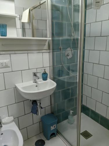 a bathroom with a sink and a shower at Appartamento Saragone in Salerno