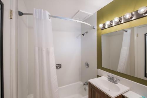 
a bathroom with a shower, sink, and tub at Americas Best Value Inn-Painted Post in Painted Post
