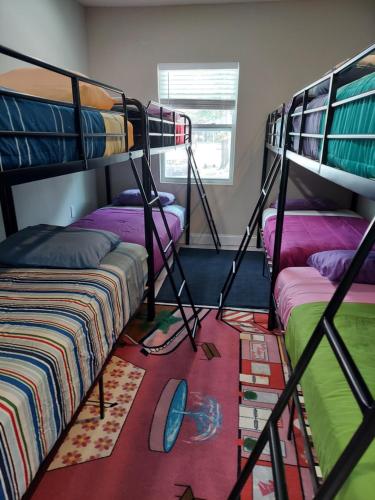 a room with two bunk beds and a rug at Nice house between two beaches. in Gulf Breeze