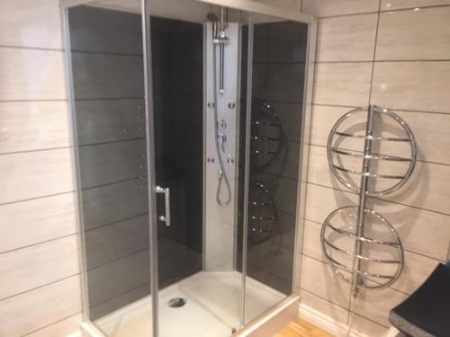 a shower with a glass door in a bathroom at Chez Thomas 7 Route du Monde Ancien in Saint-Georges-dʼAunay