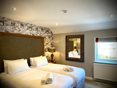 A bed or beds in a room at The General Tarleton 