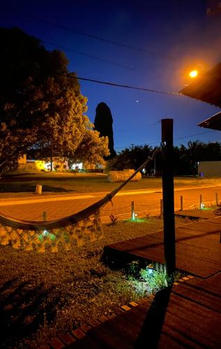 a hammock on the side of a street at night at Pousada Morro do Pico in Fernando de Noronha