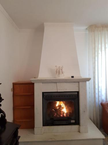 a fireplace in a living room with a fire in it at Holiday House a Firmo in Firmo