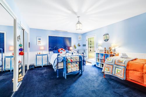 a blue bedroom with two beds and a window at Voyagers Paradise in Gualala