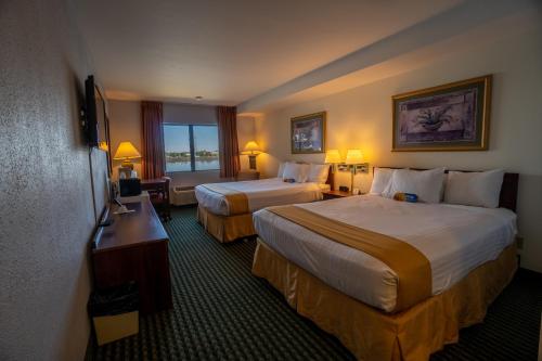 a hotel room with two beds and a television at Clover Island Inn in Kennewick