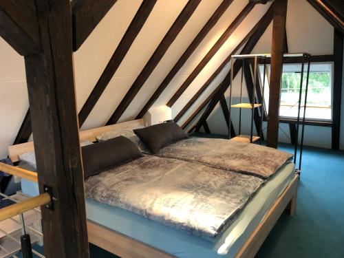a bedroom with a bed in a attic at Villa Lou in Mössingen