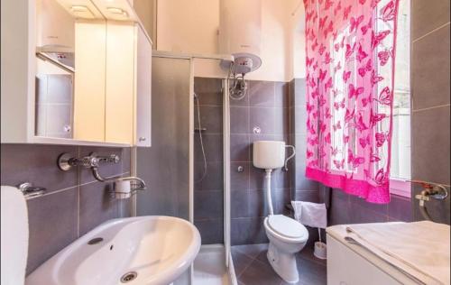 a bathroom with a white sink and a toilet at Two Room Eva in Pula