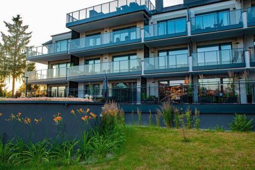 a large building with a garden in front of it at Apartament Twierdza przy plaży ROYAL APARTS OSTRÓDA in Ostróda