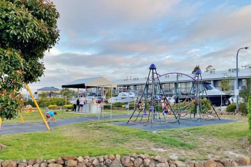 
a park filled with lots of lawn chairs and umbrellas at Eastcoaster Tasmania in Orford
