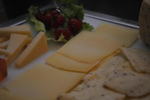 a plate of cheese and meat and a salad at Schio Hotel in Schio