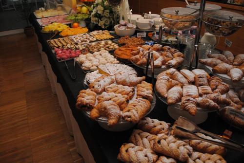 a buffet filled with lots of different types of food at Schio Hotel in Schio
