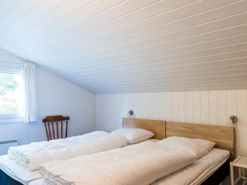 a bedroom with two beds in a room with a ceiling at Enchanting Hideaway in Henne Town-By Traum in Henne Strand