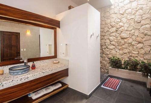 a bathroom with a sink and a mirror at Hotel Posada San Juan in Valladolid