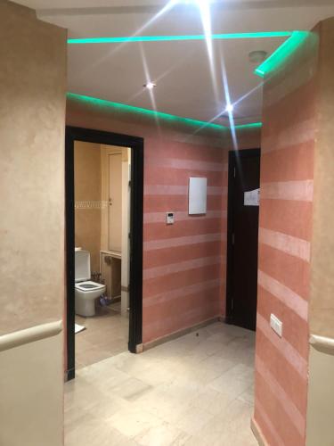 a room with a bathroom with a toilet and green lights at Appartements Marrakech Garden in Marrakesh