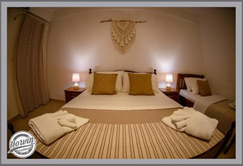 a bedroom with a bed with two towels on it at Dorvin Apartments in Dhërmi