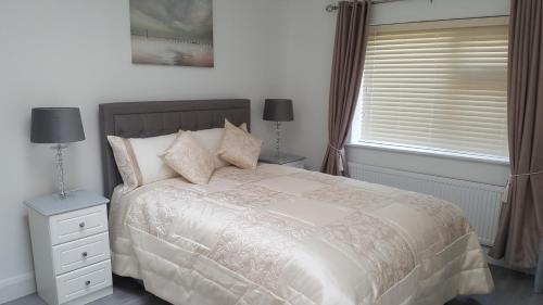 En eller flere senge i et værelse på Ashford Villa -Cottage 2