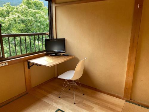 a computer sitting on a desk in front of a window at Makino Kogen 123 Building - Vacation STAY 83784 in Kaizu