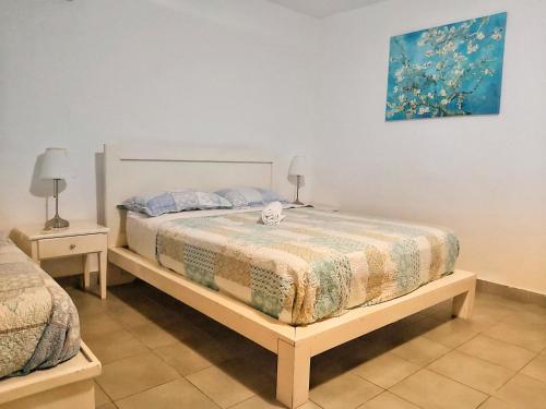 a bedroom with a bed and two night stands at Punta Cana Blue Beach Estudio in Punta Cana