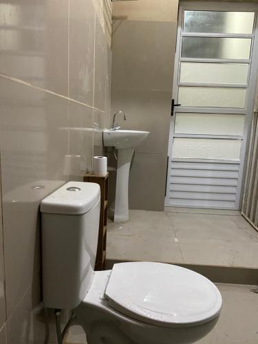 een badkamer met een toilet en een wastafel bij Apartamento aconchegante in Ubatuba
