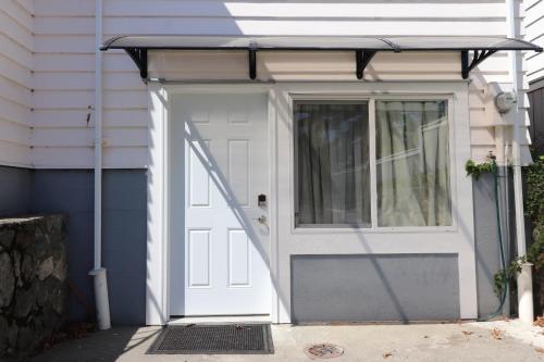 a garage with a white door and a window at Victoria Gorge Waterway Vacation Home in Victoria