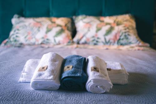 a pair of towels sitting on top of a bed at Olive Tree Suites in Eleonas