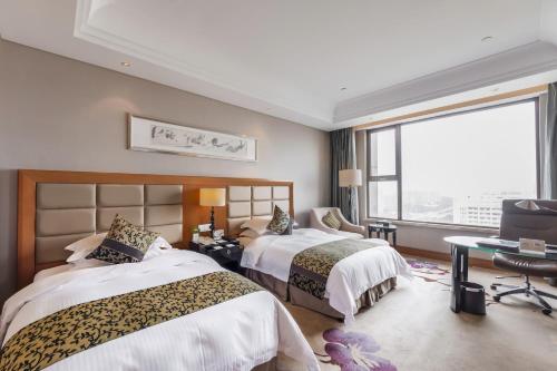 Ένα ή περισσότερα κρεβάτια σε δωμάτιο στο Wyndham Xinyang Downtown