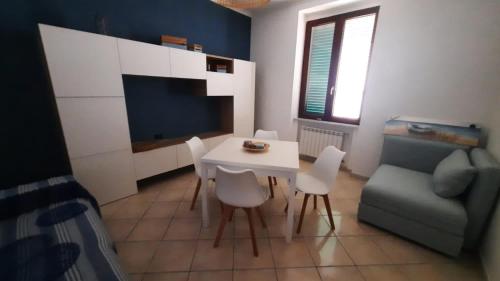 uma sala de estar com uma mesa e cadeiras e um sofá em Fenestammare em Castellammare di Stabia