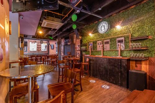 a restaurant with tables and chairs and a clock on the wall at Hotel Black Usaquen in Bogotá