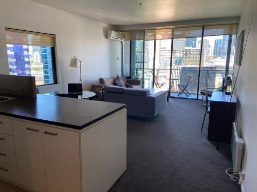 a living room with a couch and a table at AKOM AT Docklands in Melbourne