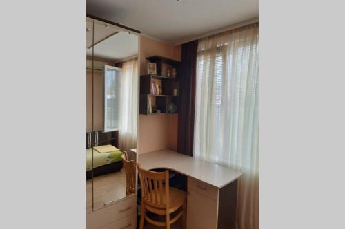 a small room with a desk and a window at Самостоятелен апартамент на брега на морето Обзор in Obzor