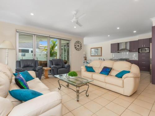 a living room with two white couches and a table at Casuarina Dreaming Townhouse with Pool in Kingscliff