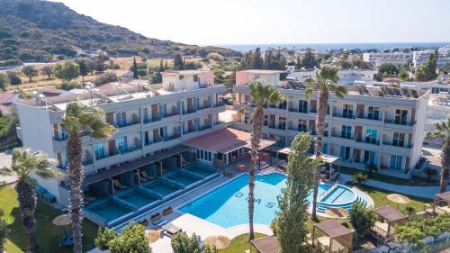 an aerial view of a hotel with a swimming pool and palm trees at Dias Studios & Suites in Faliraki