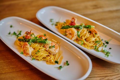 two plates of food on a table with shrimp at Hotel & Restaurant Herzstück Waldkirchen in Waldkirchen