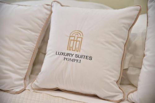 a pillow with a louvinopy suites pumpkin on it at Pompei Luxury Suite in Pompei