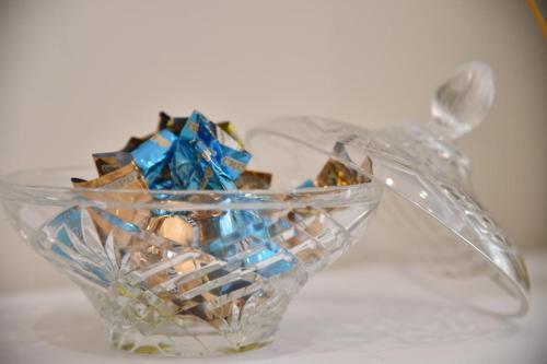 a glass container filled with differentcolored candies at Pompei Luxury Suite in Pompei