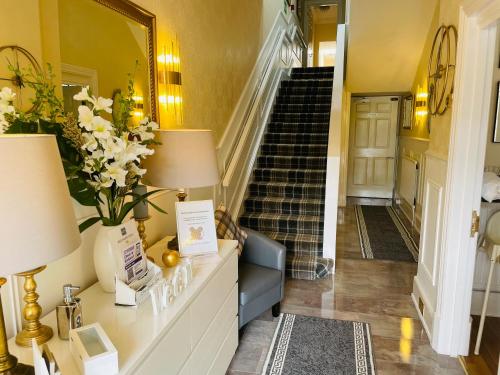 a room with a stairway leading to a staircase at Beechwood Ensuite Guest House in Ayr