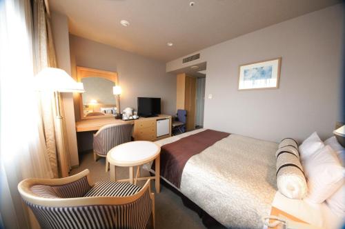Voodi või voodid majutusasutuse Numazu River Side Hotel toas