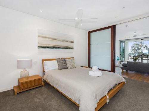 a bedroom with a bed and a large window at Kingscliff Nor Nor East 101 with Ocean Glimpses in Kingscliff