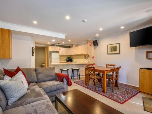 a living room with a couch and a table at Lhotsky 8 in Thredbo