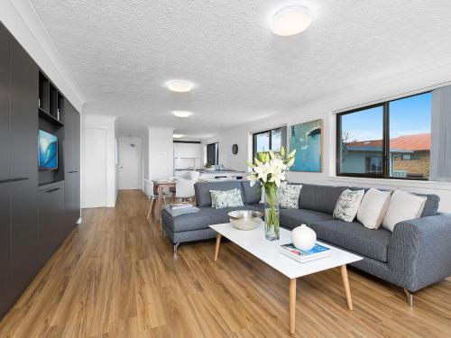 a living room with a couch and a table at Shoreline 6 with Ocean Views To See The Whales in Hastings Point