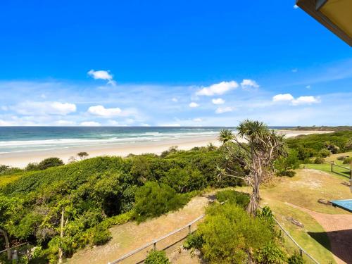 a view of the beach from the balcony of a house at Shoreline 9 Penthouse With Ocean Views in Hastings Point