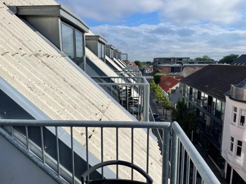 an apartment balcony with a view of a city at Herning City Hotel in Herning