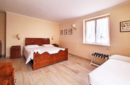 a bedroom with a large bed and a window at Borgo alla Sorgente in Vallio Terme