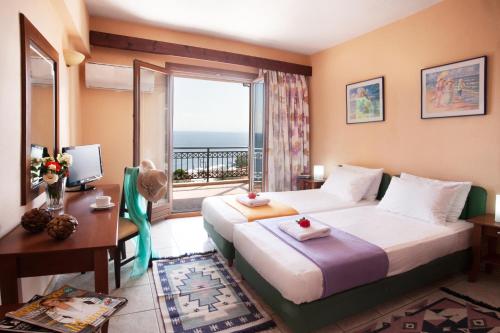 a hotel room with a bed and a window at La Luna Hotel in Troulos