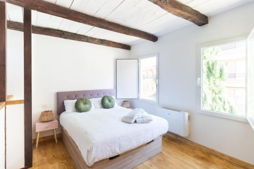 a bedroom with a bed and two windows at VUT Domus Aurea in Astorga